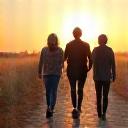 A diverse group of adults confidently walking towards a new horizon, representing life transitions